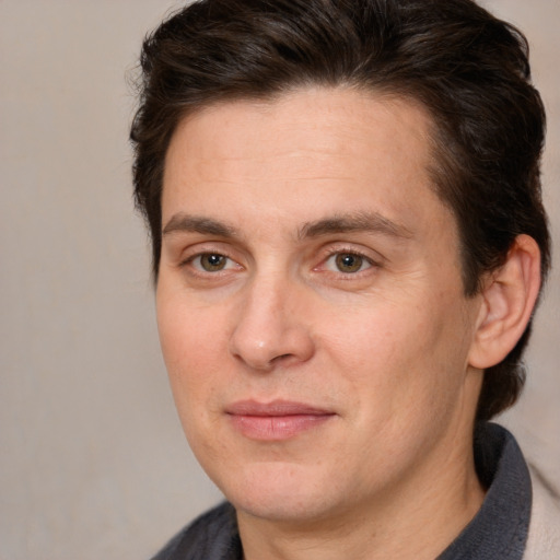 Joyful white adult male with medium  brown hair and brown eyes