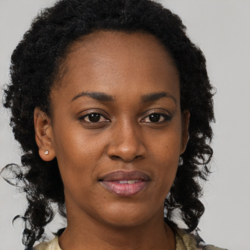 Joyful black adult female with short  brown hair and brown eyes