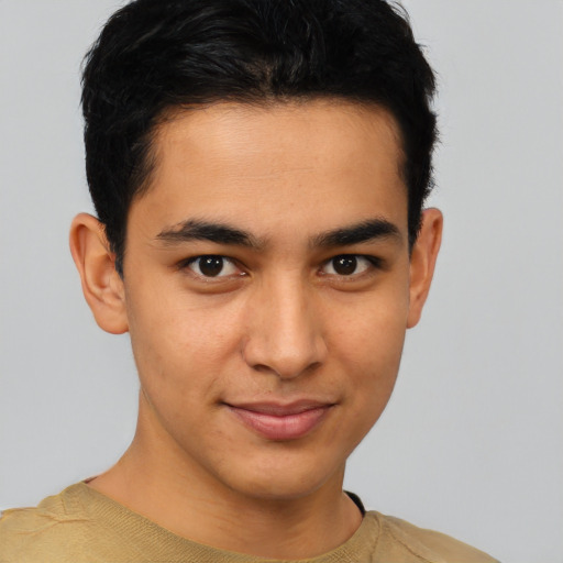 Joyful latino young-adult male with short  brown hair and brown eyes