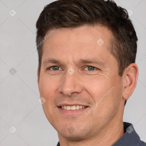 Joyful white adult male with short  brown hair and brown eyes