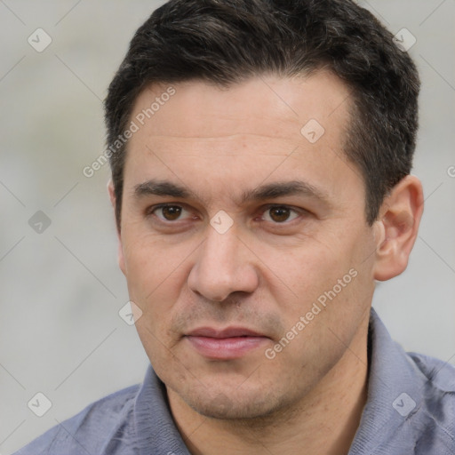 Joyful white adult male with short  black hair and brown eyes