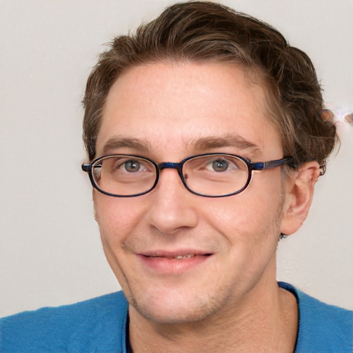 Joyful white adult male with short  brown hair and blue eyes