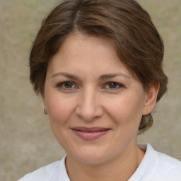 Joyful white adult female with medium  brown hair and brown eyes