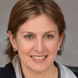 Joyful white adult female with medium  brown hair and grey eyes