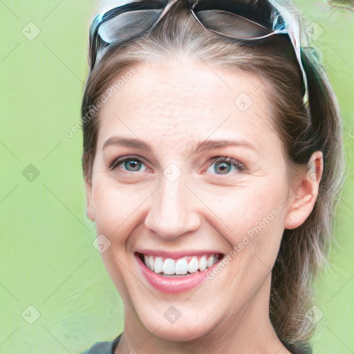 Joyful white young-adult female with medium  brown hair and blue eyes