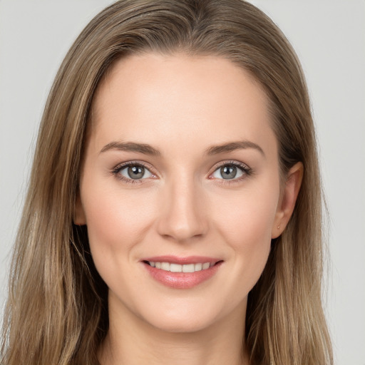 Joyful white young-adult female with long  brown hair and grey eyes