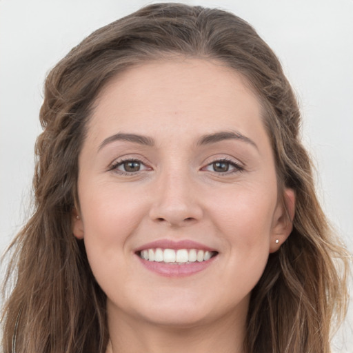 Joyful white young-adult female with long  brown hair and grey eyes