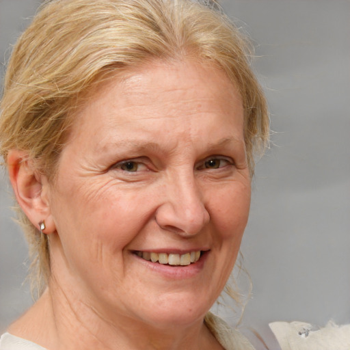 Joyful white middle-aged female with medium  blond hair and brown eyes