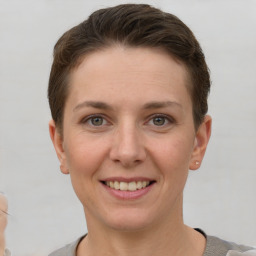 Joyful white young-adult female with short  brown hair and grey eyes