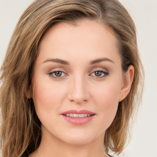 Joyful white young-adult female with long  brown hair and green eyes