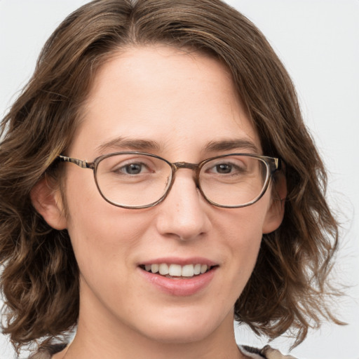 Joyful white young-adult female with medium  brown hair and blue eyes