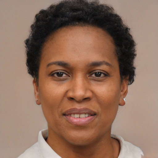 Joyful black adult female with short  brown hair and brown eyes