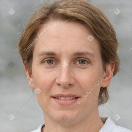 Joyful white adult female with medium  brown hair and grey eyes