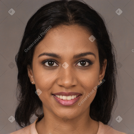 Joyful black young-adult female with medium  brown hair and brown eyes