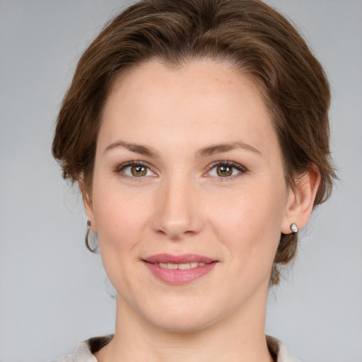 Joyful white young-adult female with medium  brown hair and grey eyes