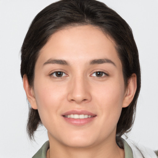 Joyful white young-adult female with medium  brown hair and brown eyes