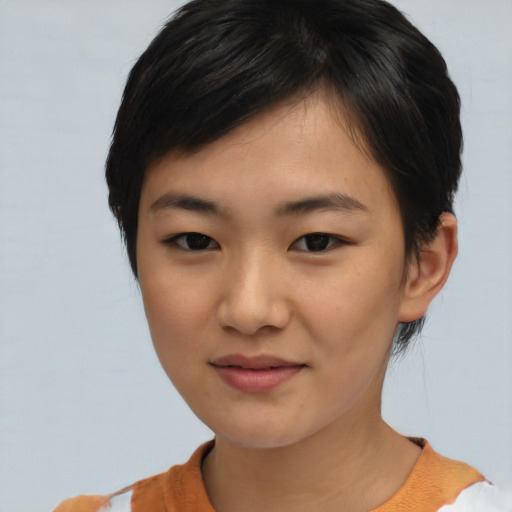 Joyful asian young-adult female with short  brown hair and brown eyes