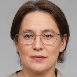 Joyful white adult female with medium  brown hair and grey eyes