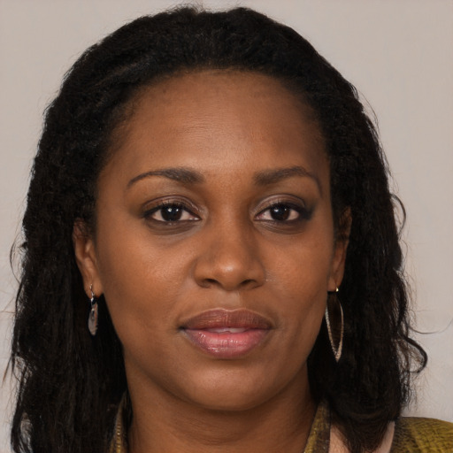 Joyful black young-adult female with long  brown hair and brown eyes