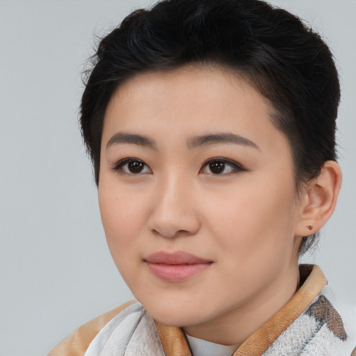 Joyful asian young-adult female with short  brown hair and brown eyes