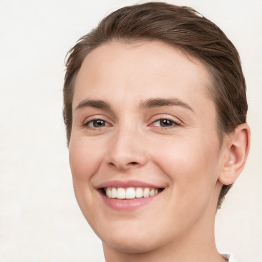 Joyful white young-adult female with short  brown hair and brown eyes