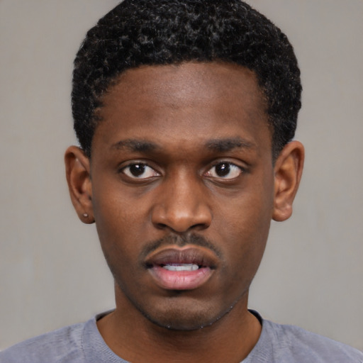 Neutral black young-adult male with short  black hair and brown eyes