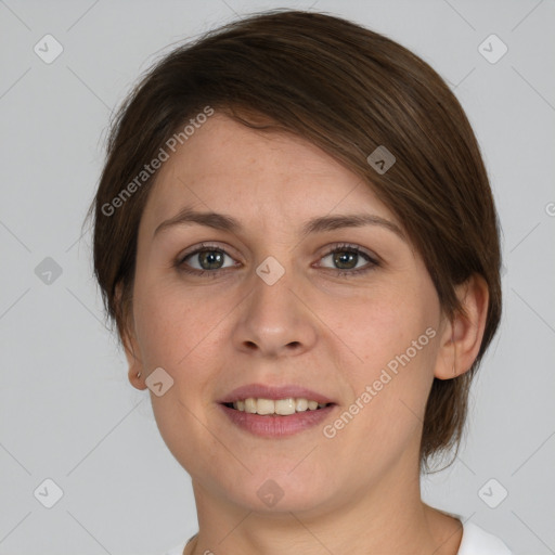 Joyful white young-adult female with medium  brown hair and grey eyes