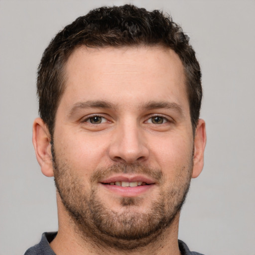 Joyful white young-adult male with short  brown hair and brown eyes