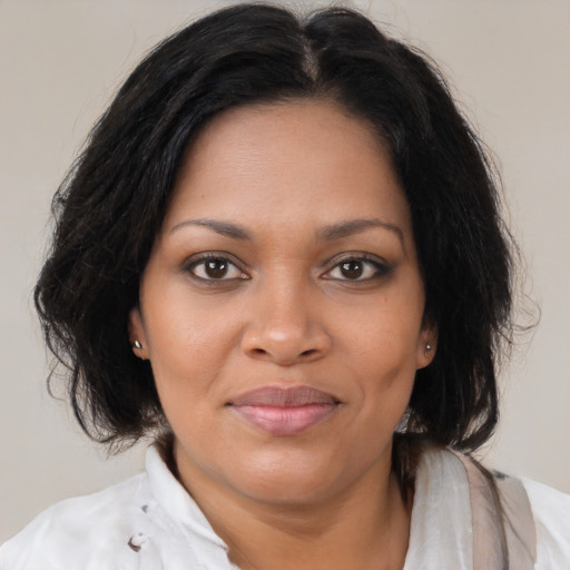 Joyful black young-adult female with medium  brown hair and brown eyes