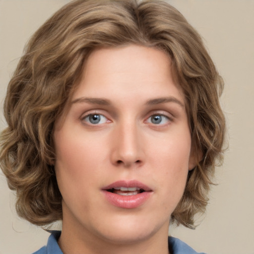 Joyful white young-adult female with medium  brown hair and blue eyes