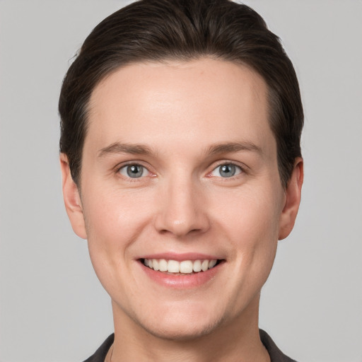 Joyful white young-adult female with short  brown hair and grey eyes