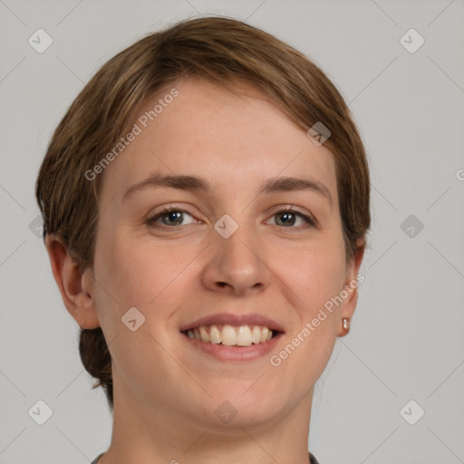 Joyful white young-adult female with short  brown hair and grey eyes