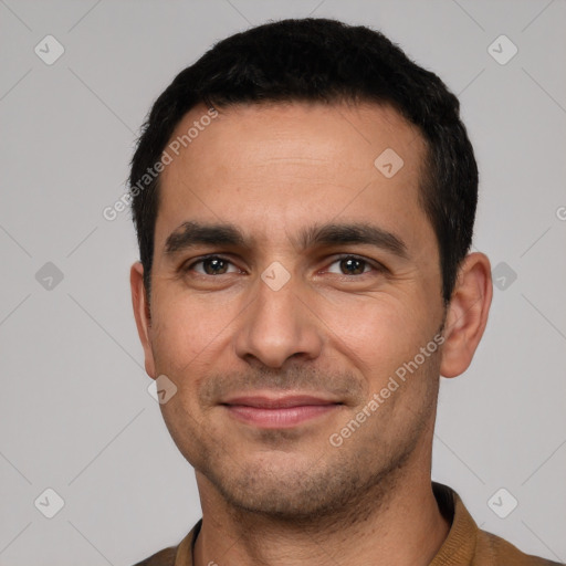 Joyful white young-adult male with short  black hair and brown eyes