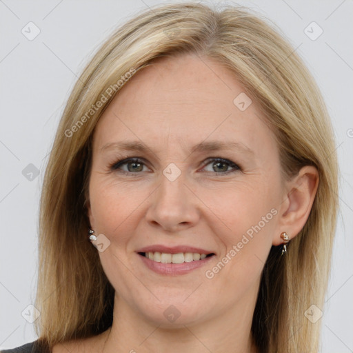 Joyful white adult female with long  brown hair and brown eyes