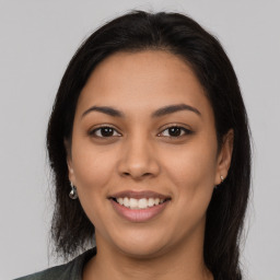 Joyful latino young-adult female with long  brown hair and brown eyes