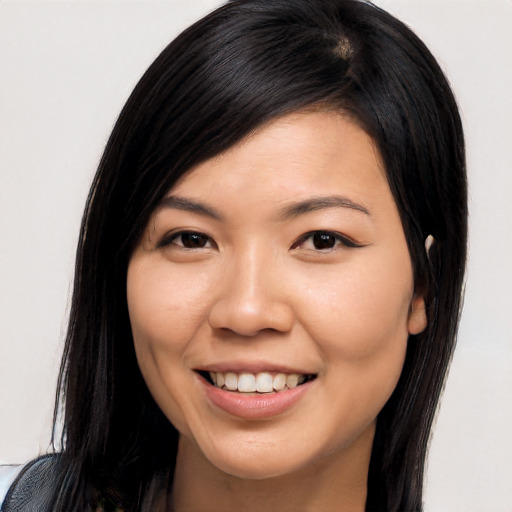 Joyful asian young-adult female with long  brown hair and brown eyes
