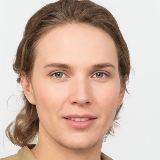 Joyful white young-adult female with medium  brown hair and grey eyes