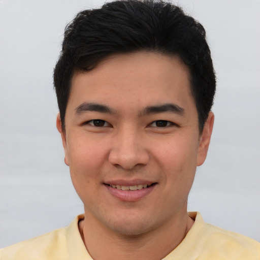 Joyful asian young-adult male with short  brown hair and brown eyes