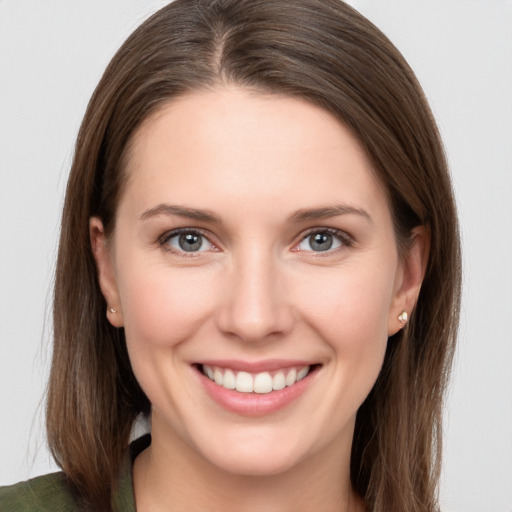 Joyful white young-adult female with long  brown hair and grey eyes