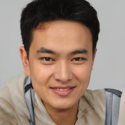 Joyful asian young-adult male with short  brown hair and brown eyes