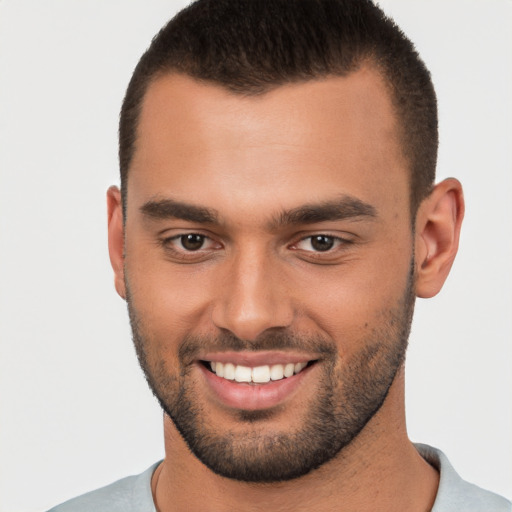 Joyful white young-adult male with short  brown hair and brown eyes