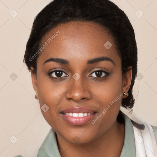 Joyful black young-adult female with long  black hair and brown eyes