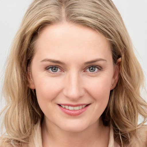 Joyful white young-adult female with long  brown hair and grey eyes