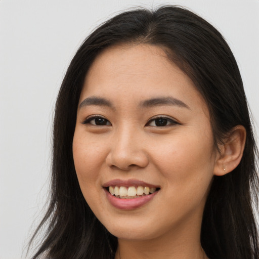 Joyful asian young-adult female with long  brown hair and brown eyes