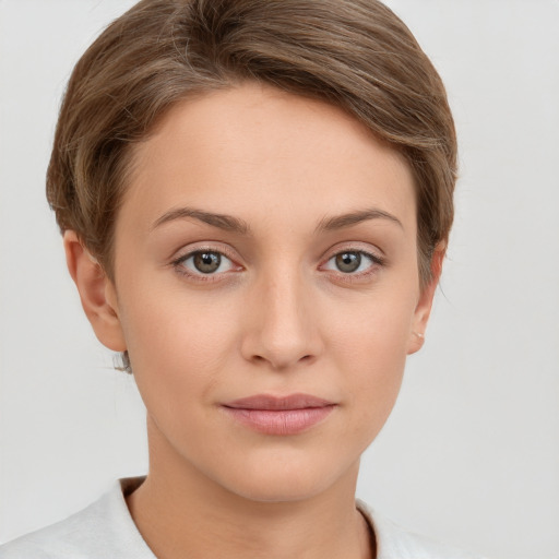 Joyful white young-adult female with short  brown hair and grey eyes