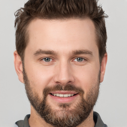 Joyful white young-adult male with short  brown hair and brown eyes