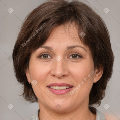 Joyful white adult female with medium  brown hair and brown eyes