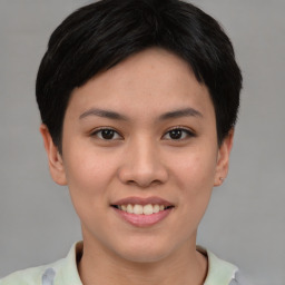 Joyful asian young-adult female with short  brown hair and brown eyes