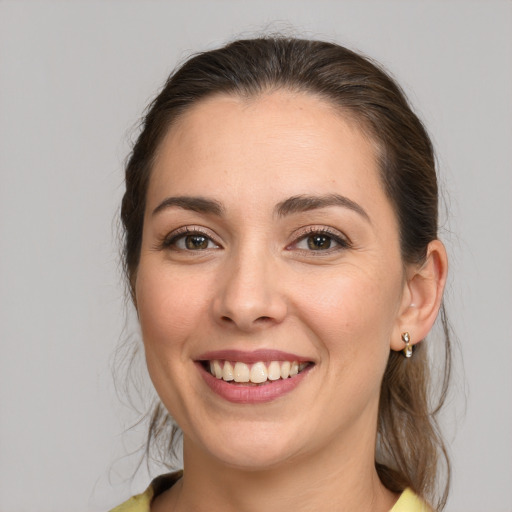 Joyful white young-adult female with medium  brown hair and brown eyes