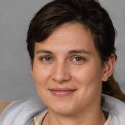 Joyful white young-adult female with medium  brown hair and grey eyes